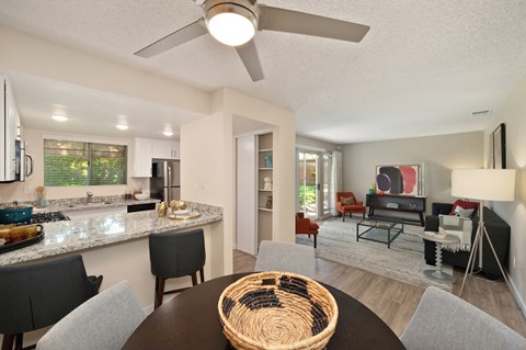 Dining Area with Kitchen, Ceiling Fan/Light, Black Table and Granite Countertop